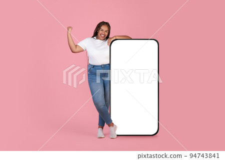 Black Woman Posing Near Huge Smartphone Gesturing Yes, Pink Background Black Woman Posing Near Huge Smartphone Gesturing Yes, Pink Background 94743841
