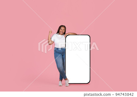 African American Female Near Big Smartphone Screen Over Pink Background African American Female Near Big Smartphone Screen Over Pink Background 94743842