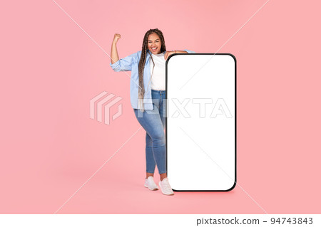 African Woman Near Large Phone Gesturing Yes On Pink Background African Woman Near Large Phone Gesturing Yes On Pink Background 94743843