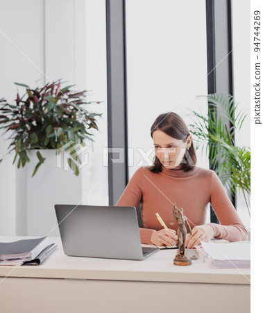 business person is a woman lawyer entrepreneur in the office working with a laptop. successful  94744269