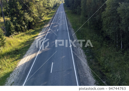 two-lane road in the forest in the summer on a sunny day two-lane road in the forest in the summer on a sunny day 94744763