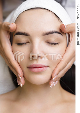 Professional anti-aging facial massage. Action. Relaxing facial treatment at Spa. Relaxing and rejuvenating facial massage for women Professional anti-aging facial massage. Action. Relaxing facial treatment at Spa. Relaxing and rejuvenating facial massage for women 94745359