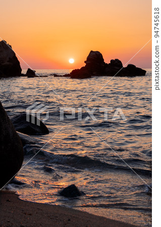 Beautiful view of orange sunset seascape with rocks in Italy. Colorful sunrise landscape Beautiful view of orange sunset seascape with rocks in Italy. Colorful sunrise landscape 94745618