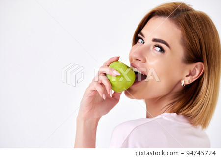girl holding green apple isolated on white background girl holding green apple isolated on white background 94745724
