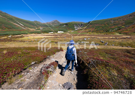 Child climbing Asahidake in autumn Child climbing Asahidake in autumn 94746728