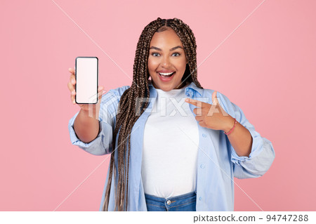 Joyful Black Lady Showing Mobie Phone Blank Screen, Pink Background Joyful Black Lady Showing Mobie Phone Blank Screen, Pink Background 94747288