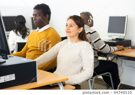 Hispanic woman and african american man studying in computer library 94748510