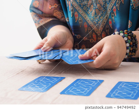 Asian woman choosing cards in tarot reading 94749492