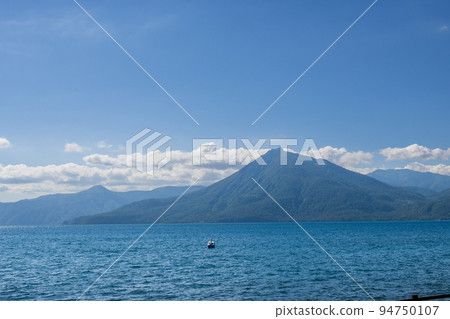 Beautiful Lake Shikotsu blue under the summer blue sky Beautiful Lake Shikotsu blue under the summer blue sky 94750107