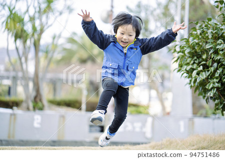 A cute boy full of energy jumping 94751486