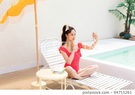 summer vacation concept_korean beautiful asian young woman taking a selfie sitting on the sunbed summer vacation concept_korean beautiful asian young woman taking a selfie sitting on the sunbed 94753261
