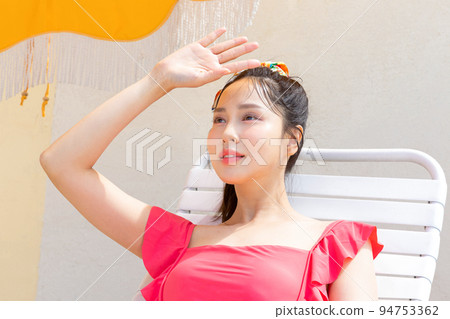 summer vacation concept_korean beautiful asian young woman covering face by hand of bright sunlight 94753362