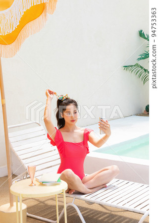 summer vacation concept_korean beautiful asian young woman taking a selfie sitting on the sunbed 94753363
