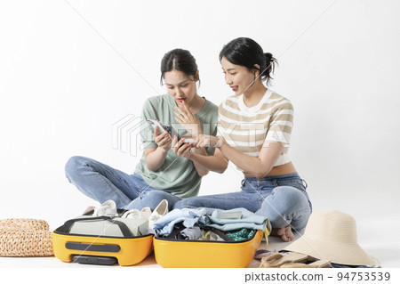 preparing for a summer trip concept series_korean beautiful asian young women watching smartphone preparing for a summer trip concept series_korean beautiful asian young women watching smartphone 94753539