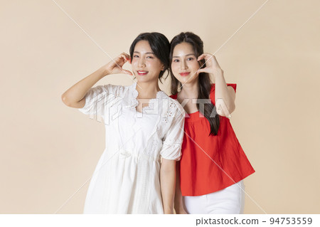 summer vacation trip with friends concept series_korean beautiful asian young women heart shape hand motions summer vacation trip with friends concept series_korean beautiful asian young women heart shape hand motions 94753559