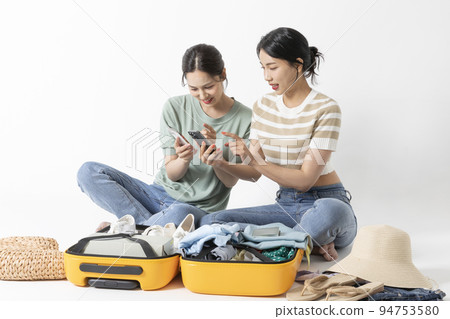 preparing for a summer trip concept series_korean beautiful asian young women watching smartphone preparing for a summer trip concept series_korean beautiful asian young women watching smartphone 94753580
