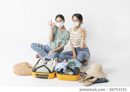 preparing for a summer trip concept series_korean beautiful asian young women holding masks preparing for a summer trip concept series_korean beautiful asian young women holding masks 94753581