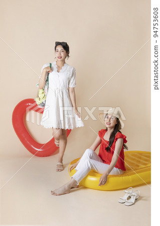 summer vacation trip with friends concept series_korean beautiful asian young women sitting on pool floats 94753608