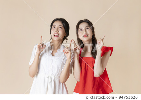 summer vacation trip with friends concept series_korean beautiful asian young women pointing to direction summer vacation trip with friends concept series_korean beautiful asian young women pointing to direction 94753626