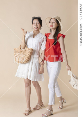 summer vacation trip with friends concept series_korean beautiful asian young women walking while pointing at the direction summer vacation trip with friends concept series_korean beautiful asian young women walking while pointing at the direction 94753628