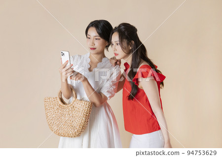 summer vacation trip with friends concept series_korean beautiful asian young women watching smartphone summer vacation trip with friends concept series_korean beautiful asian young women watching smartphone 94753629