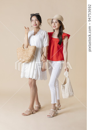 summer vacation trip with friends concept series_korean beautiful asian young women walking while pointing at the direction summer vacation trip with friends concept series_korean beautiful asian young women walking while pointing at the direction 94753692