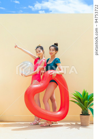 summer vacation trip with friends concept series_korean beautiful asian young women holding a tube and pool float ball 94753722