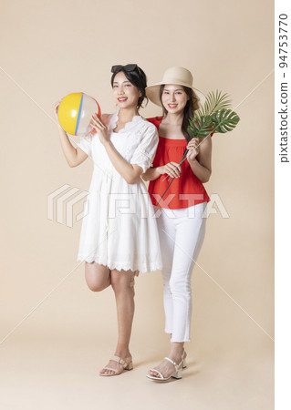 summer vacation trip with friends concept series_korean beautiful asian young women holding a pool float ball and leaves summer vacation trip with friends concept series_korean beautiful asian young women holding a pool float ball and leaves 94753770