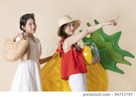summer vacation trip with friends concept series_korean beautiful asian young women holding a pool float ball and tube summer vacation trip with friends concept series_korean beautiful asian young women holding a pool float ball and tube 94753797