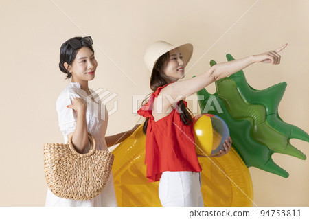 summer vacation trip with friends concept series_korean beautiful asian young women walking holding a tube and pool float ball 94753811