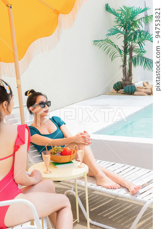 summer vacation trip with friends concept series_korean beautiful asian young women taking a rest on the sunbed 94753821