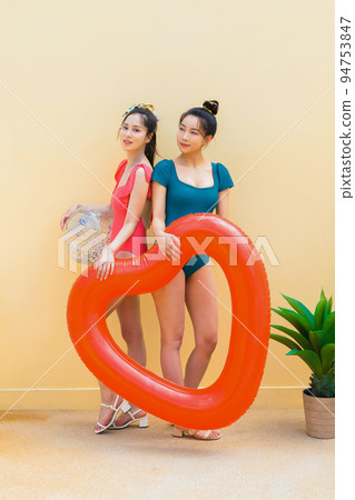 summer vacation trip with friends concept series_korean beautiful asian young women holding a tube and pool float ball summer vacation trip with friends concept series_korean beautiful asian young women holding a tube and pool float ball 94753847