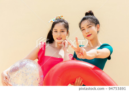 summer vacation trip with friends concept series_korean beautiful asian young women holding a pool float ball with hand motions summer vacation trip with friends concept series_korean beautiful asian young women holding a pool float ball with hand motions 94753891