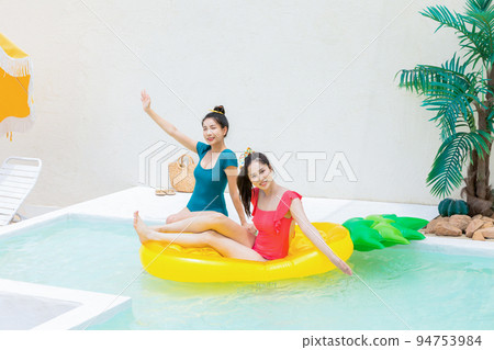summer vacation trip with friends concept series_korean beautiful asian young women sitting on pool floats and playing on the water summer vacation trip with friends concept series_korean beautiful asian young women sitting on pool floats and playing on the water 94753984