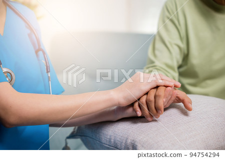 Young woman helping hold hands offering her senior man 94754294