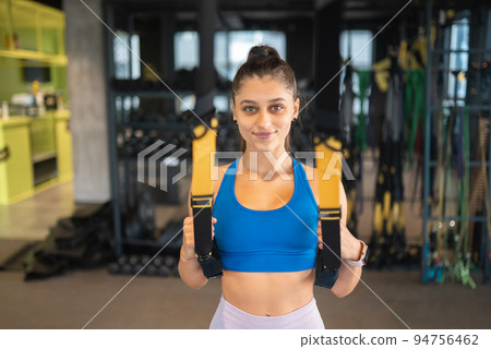 Woman doing exercises with trx fitness straps in the gym 94756462