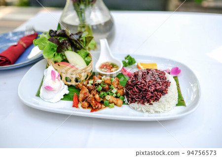 Stir-fried pork belly with garlic and chili, serve with rice and poached egg Stir-fried pork belly with garlic and chili, serve with rice and poached egg 94756573