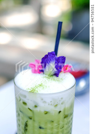 Iced Matcha latte tea with a blur background. 94756581