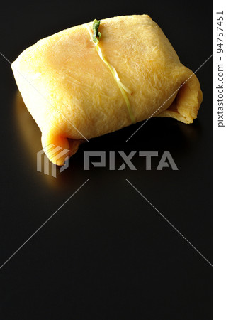 Take a picture of chakin sushi, a treat for the day of hare, on a black background Take a picture of chakin sushi, a treat for the day of hare, on a black background 94757451