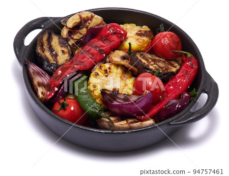 Grilled vegetables in black ceramic plate isolated on white background Grilled vegetables in black ceramic plate isolated on white background 94757461