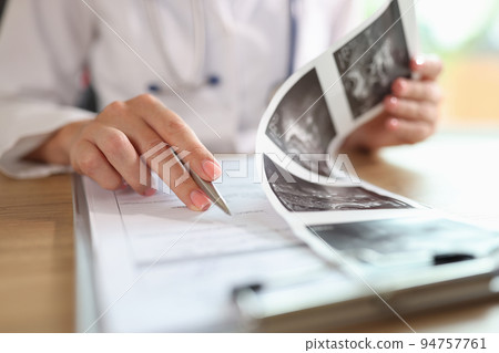 Gynecologist examines results of examination of uterus Gynecologist examines results of examination of uterus 94757761