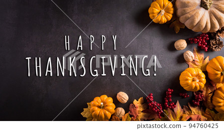 Thanksgiving and Autumn composition. Pumpkin, cotton flowers and autumn leaves on dark stone background. Flat lay, top view with copy space. 94760425