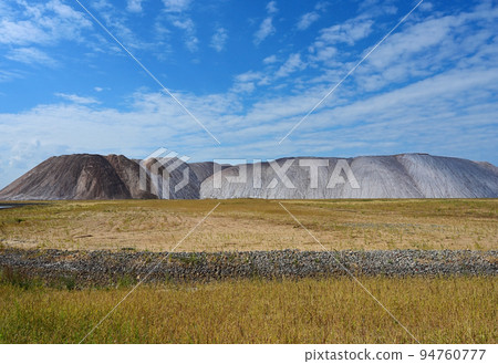 Potash waste heaps against the blue sky 94760777