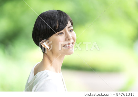 Young woman listening to music outdoors 94761315