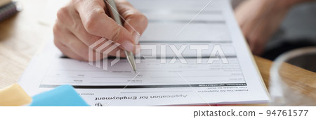 Person fill application for employment paper in company office Person fill application for employment paper in company office 94761577