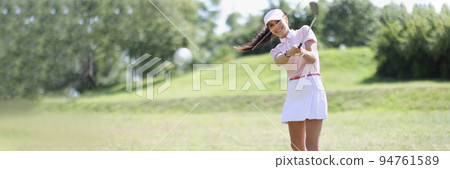 Professional female golf player hit ball with golf club on field Professional female golf player hit ball with golf club on field 94761589