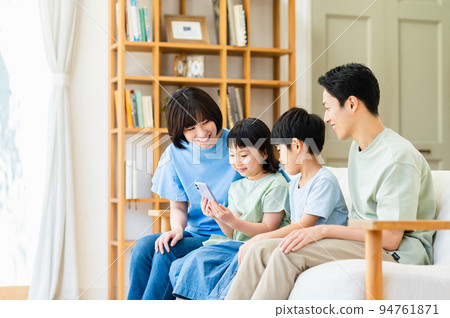 A family relaxing in the living room 94761871