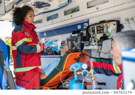 Ambulance staff preparing the respiratory patient for oxygenation Ambulance staff preparing the respiratory patient for oxygenation 94763174