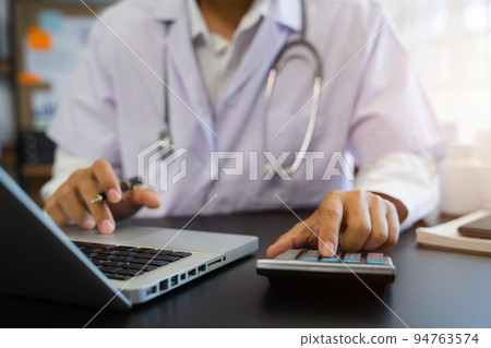 Doctor working in hospital use calculator, Healthcare and medical concept. 94763574
