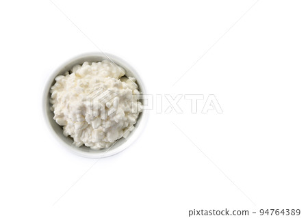 Fresh cottage cheese isolated on white background. Top view. Copy space Fresh cottage cheese isolated on white background. Top view. Copy space 94764389